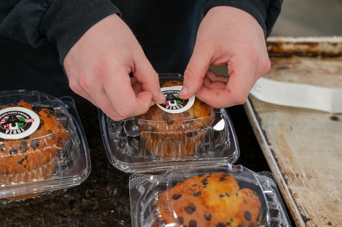 Homemade Forza protein muffins being packed by hand